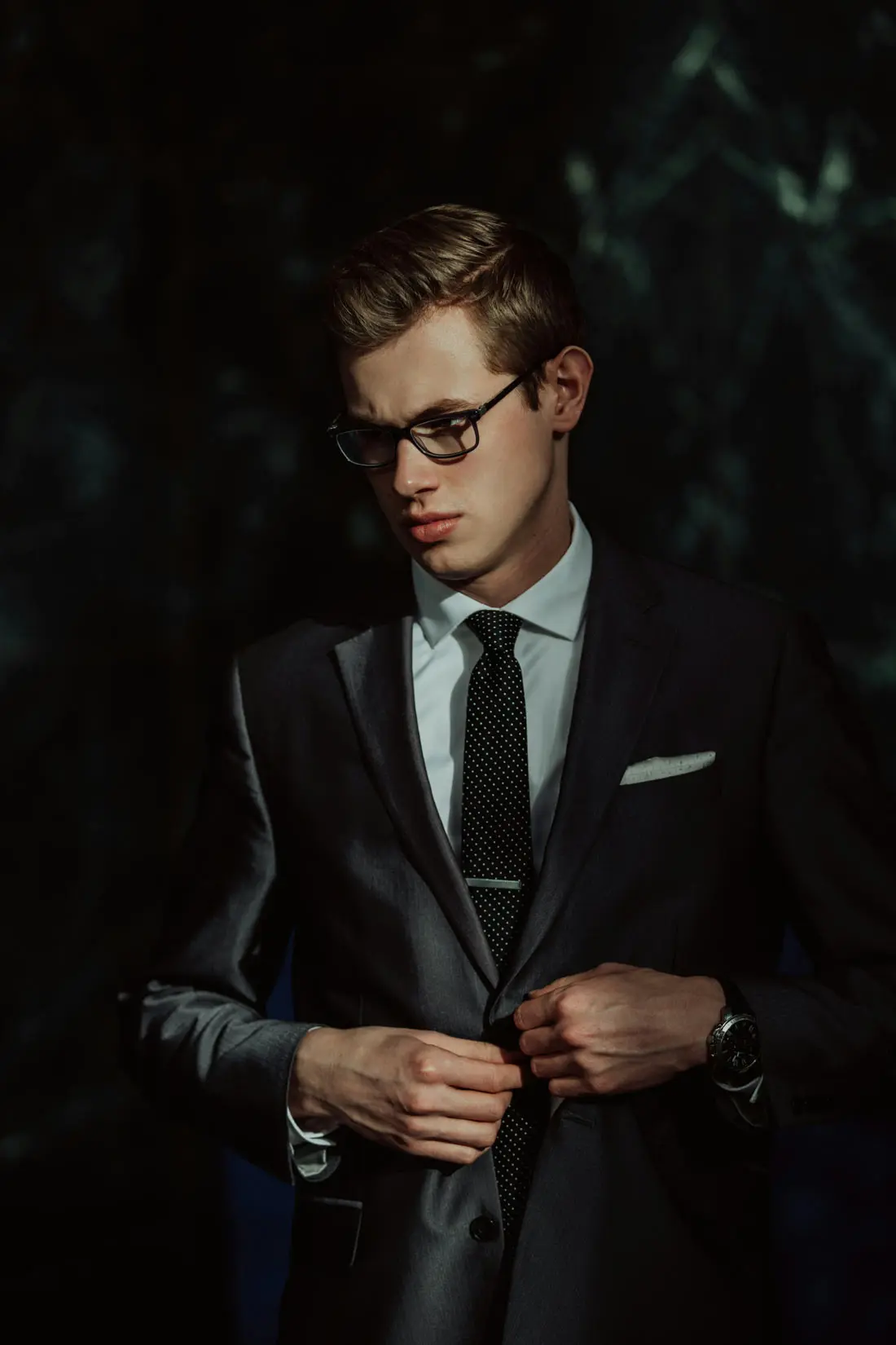 Tailor adjusting a men’s suit jacket in a London alterations boutique